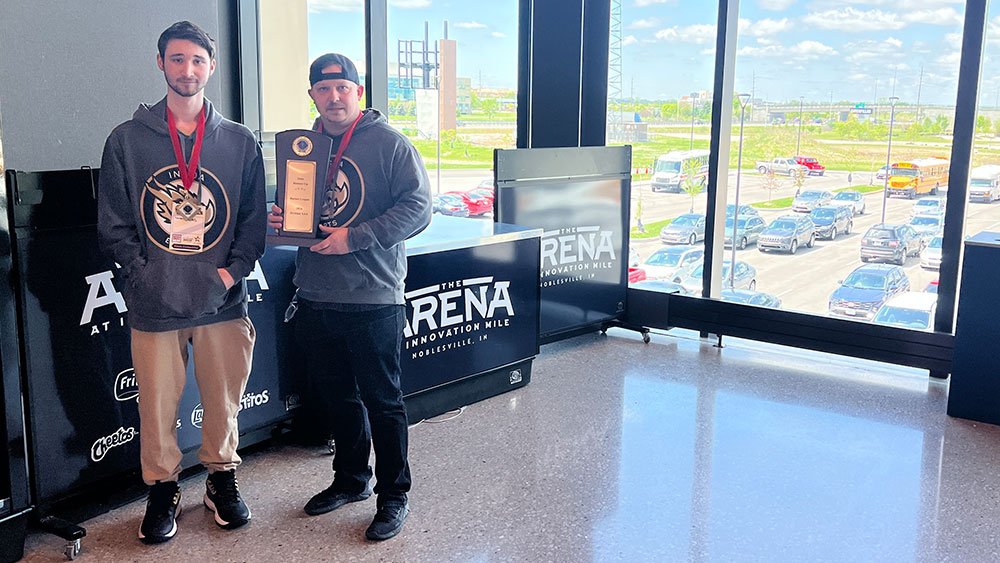 INGDA Clubs and Esports Coordinator Danny Patton and INGDA senior Landon Kerkes pose with the Rocket League State Runner-Up trophy. (Reporter photo)