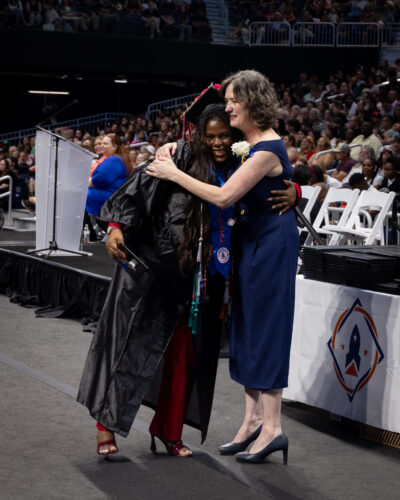 director hugging a student